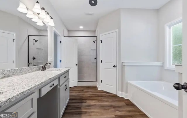 0 Nocona Trl, Ellijay, GA 30536 - full bath featuring a garden tub, vanity, tiled shower, wood finished floors, and recessed lighting