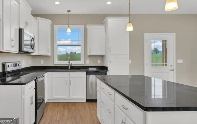 0 Nocona Trl, Ellijay, GA 30536 - kitchen featuring appliances with stainless steel finishes, a kitchen island, white cabinetry, light wood-style flooring, and recessed lighting