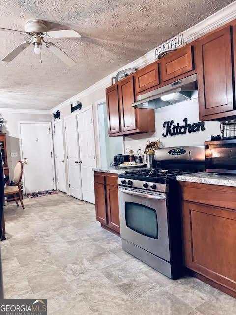 791 Bristol Way, Lithonia, GA 30058 - kitchen with appliances with stainless steel finishes, under cabinet range hood, ornamental molding, a ceiling fan, and light countertops