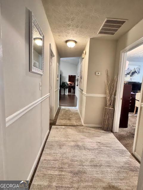 791 Bristol Way, Lithonia, GA 30058 - hallway with carpet and a textured ceiling