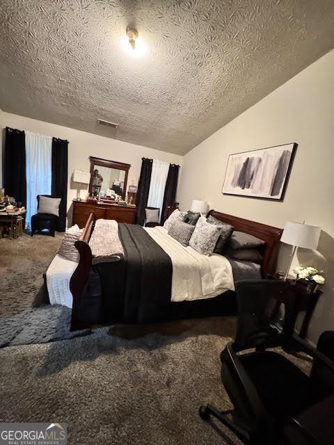 791 Bristol Way, Lithonia, GA 30058 - bedroom featuring carpet, a textured ceiling, and vaulted ceiling