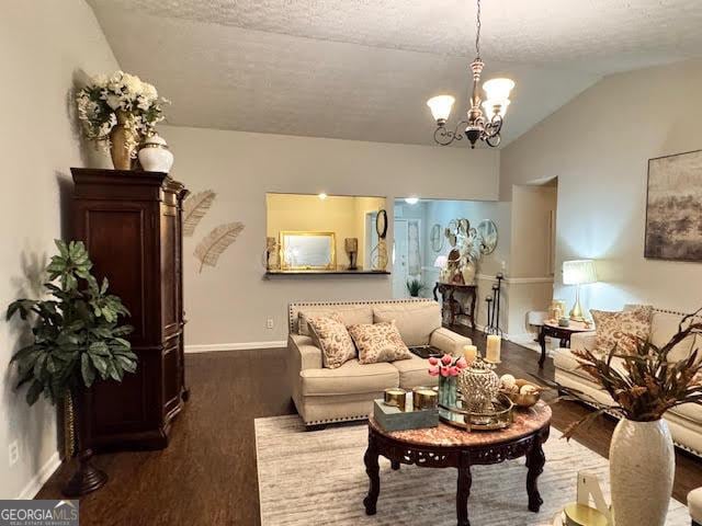 791 Bristol Way, Lithonia, GA 30058 - living area with wood finished floors, a chandelier, lofted ceiling, and a textured ceiling
