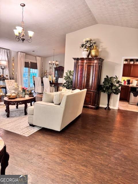 791 Bristol Way, Lithonia, GA 30058 - living room with a chandelier, a textured ceiling, wood finished floors, and lofted ceiling