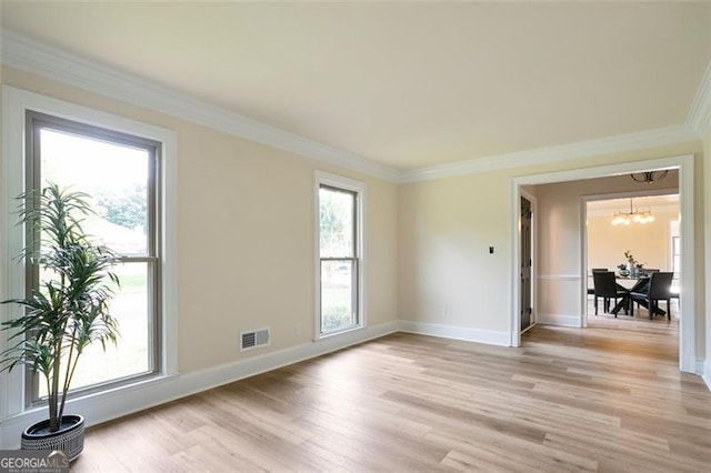 300 Saddle Creek Ln, Roswell, GA 30076 - spare room featuring healthy amount of natural light, ornamental molding, and light wood finished floors
