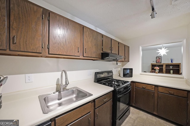 3907 Cedar Cir, Tucker, GA 30084 - kitchen featuring black gas range oven, light countertops, under cabinet range hood, dark brown cabinets, and a textured ceiling