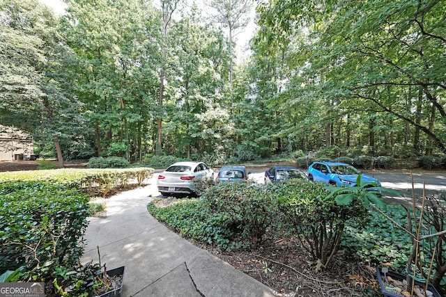 3907 Cedar Cir, Tucker, GA 30084 - view of parking / parking lot with a forest view