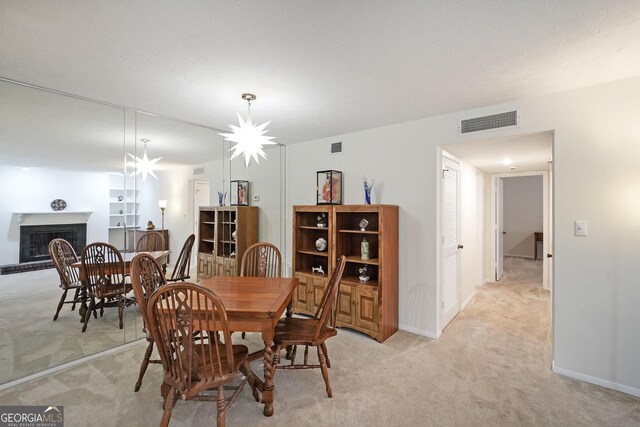 3907 Cedar Cir, Tucker, GA 30084 - dining area with light colored carpet and a fireplace with raised hearth