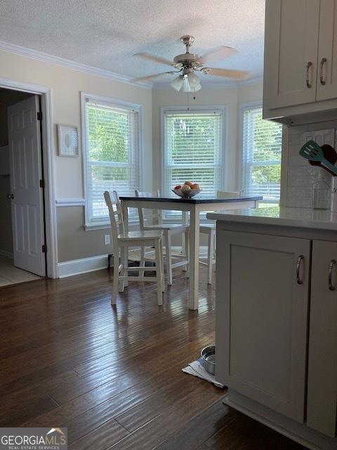 201 William D Evans Ct, Kathleen, GA 31047 - dining room with ornamental molding, ceiling fan, plenty of natural light, a textured ceiling, and dark wood-style floors