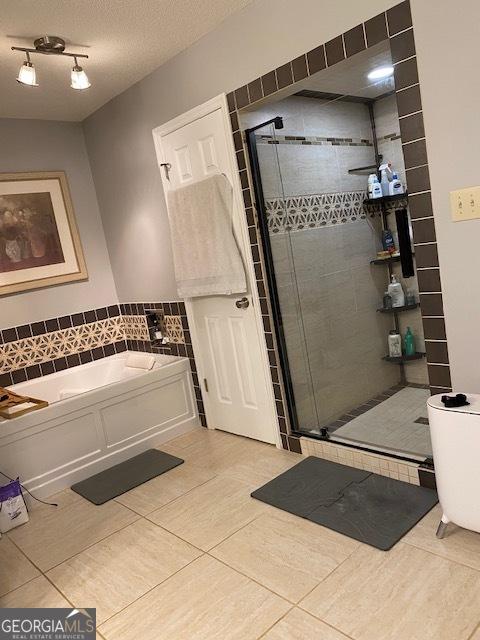 201 William D Evans Ct, Kathleen, GA 31047 - bathroom with tile patterned floors, a bath, and a shower stall