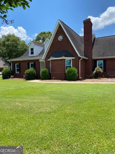 201 William D Evans Ct, Kathleen, GA 31047 - view of front of property with brick siding, a front lawn, and a chimney