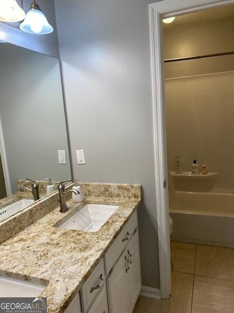 201 William D Evans Ct, Kathleen, GA 31047 - bathroom featuring vanity, tile patterned floors, and tub / shower combination
