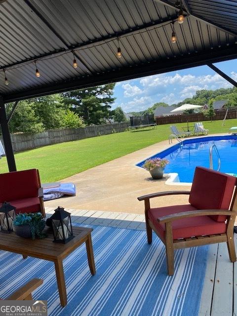 201 William D Evans Ct, Kathleen, GA 31047 - view of pool featuring a trampoline, a fenced backyard, and a patio