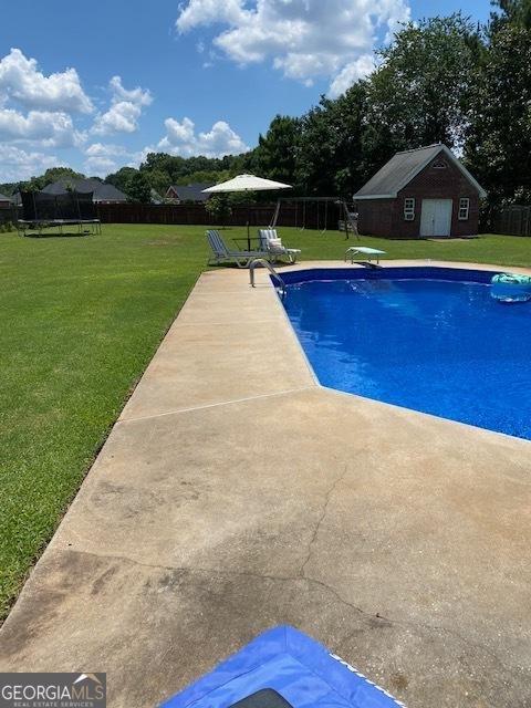 201 William D Evans Ct, Kathleen, GA 31047 - view of pool with a trampoline, a patio, and an outdoor structure