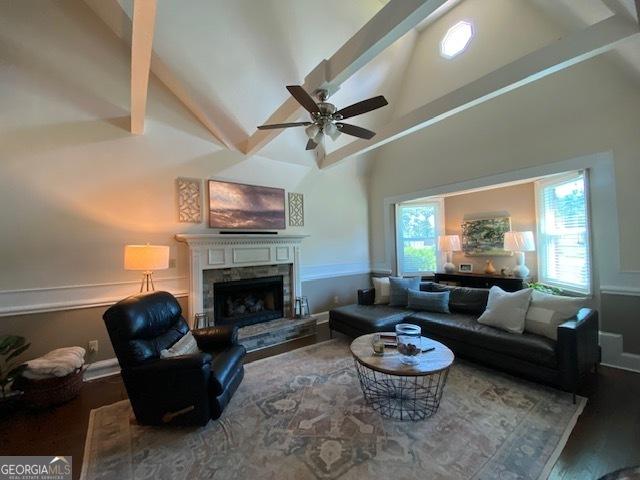 201 William D Evans Ct, Kathleen, GA 31047 - living area featuring a ceiling fan, beamed ceiling, a fireplace with raised hearth, high vaulted ceiling, and wood finished floors