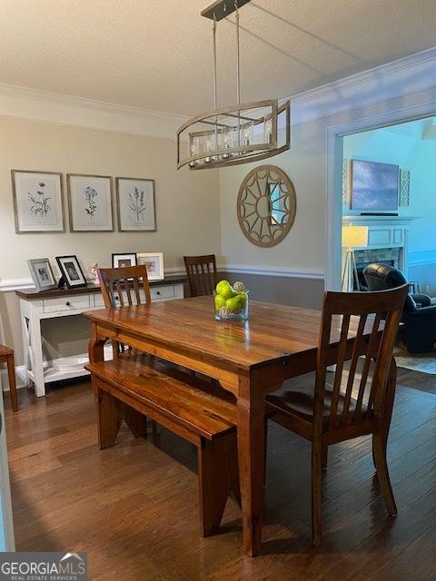 201 William D Evans Ct, Kathleen, GA 31047 - dining space featuring ornamental molding, wood finished floors, a fireplace, and a chandelier