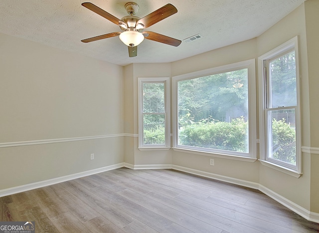 85 Holly Springs Rd, Sharpsburg, GA 30277 - spare room featuring wood finished floors, a ceiling fan, and a textured ceiling