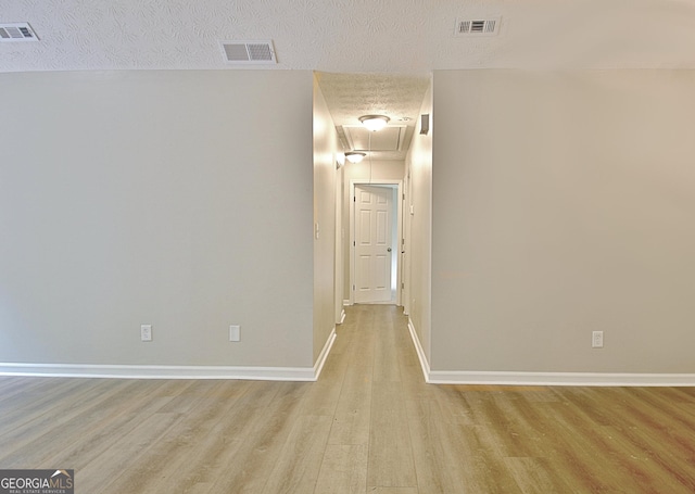 85 Holly Springs Rd, Sharpsburg, GA 30277 - corridor with attic access, light wood-style floors, and a textured ceiling