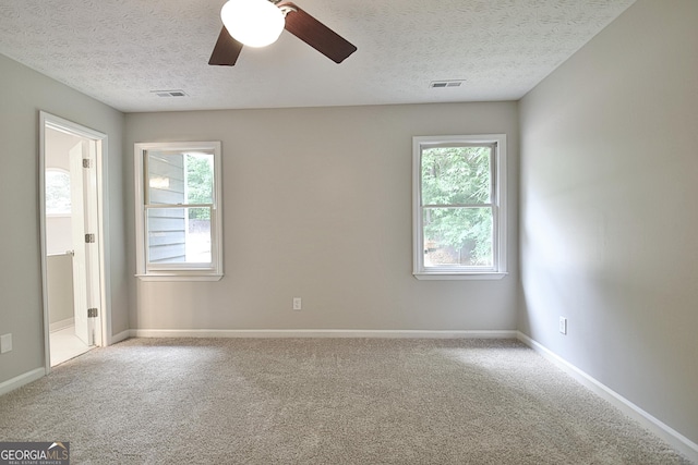 85 Holly Springs Rd, Sharpsburg, GA 30277 - spare room featuring a textured ceiling, carpet, healthy amount of natural light, and a ceiling fan