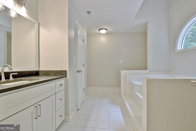 85 Holly Springs Rd, Sharpsburg, GA 30277 - bathroom with vanity, a bath, tile patterned floors, and a textured ceiling