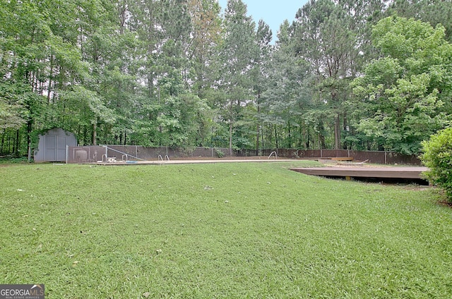 85 Holly Springs Rd, Sharpsburg, GA 30277 - fenced backyard with a storage shed and a wooden deck