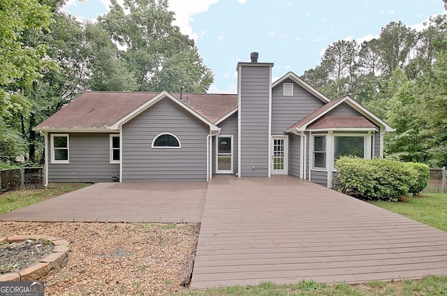 85 Holly Springs Rd, Sharpsburg, GA 30277 - rear view of house featuring a deck and a chimney