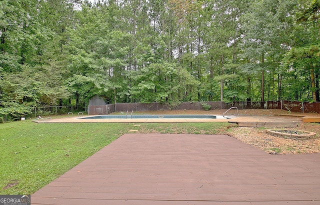85 Holly Springs Rd, Sharpsburg, GA 30277 - wooden terrace with a storage unit and a fenced backyard