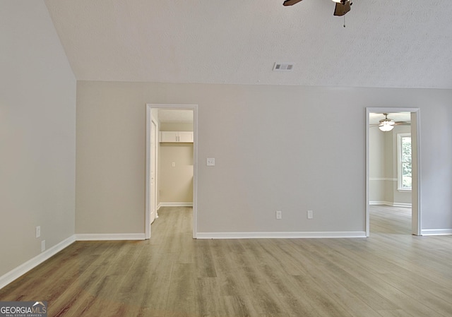 85 Holly Springs Rd, Sharpsburg, GA 30277 - empty room with a ceiling fan, light wood finished floors, a textured ceiling, and vaulted ceiling