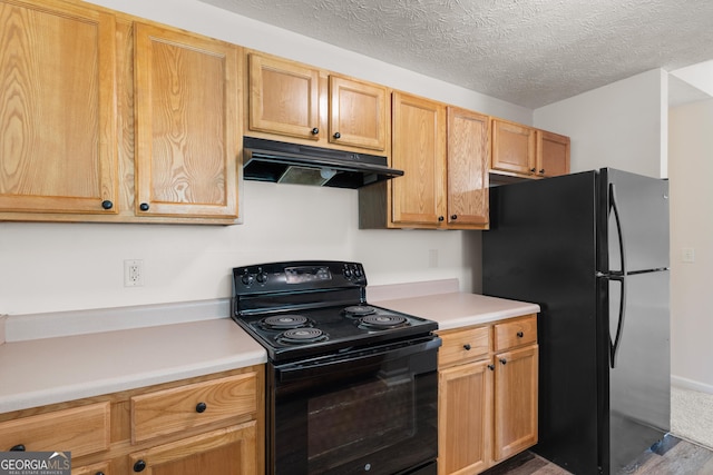 120 Bramble Bush Trl, Covington, GA 30014 - kitchen featuring black appliances, under cabinet range hood, light countertops, a textured ceiling, and wood finished floors