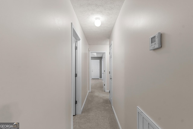 120 Bramble Bush Trl, Covington, GA 30014 - hallway with light carpet and a textured ceiling