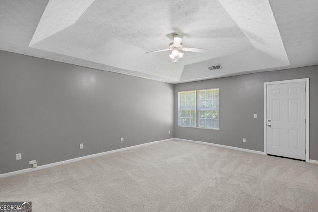 120 Bramble Bush Trl, Covington, GA 30014 - carpeted spare room featuring a raised ceiling, a textured ceiling, and ceiling fan