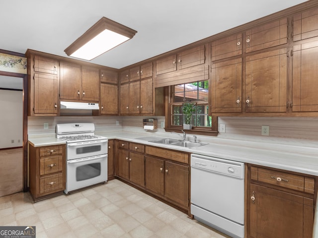 25 Ridgeview Dr, Jonesboro, GA 30236 - kitchen featuring white appliances, under cabinet range hood, light countertops, light floors, and brown cabinetry
