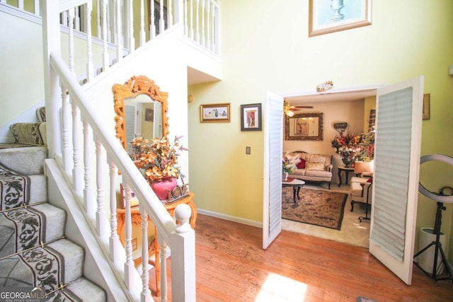 1455 Duren Farms Dr, Lithonia, GA 30058 - staircase with a towering ceiling, wood finished floors, and a ceiling fan