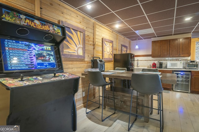 444 Miners Mountain Rd, Sautee Nacoochee, GA 30571 - bar area with wine cooler, white microwave, freestanding refrigerator, wooden walls, and a drop ceiling