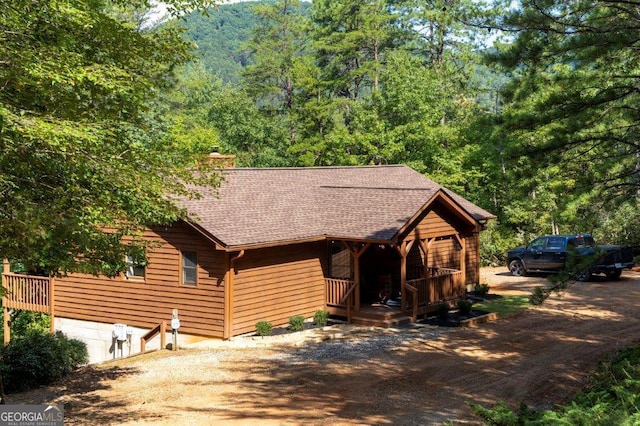 444 Miners Mountain Rd, Sautee Nacoochee, GA 30571 - chalet / cabin featuring a shingled roof, a chimney, a porch, a forest view, and dirt driveway