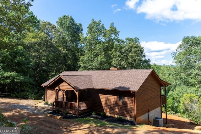 444 Miners Mountain Rd, Sautee Nacoochee, GA 30571 - view of property exterior with a chimney, roof with shingles, and a view of trees