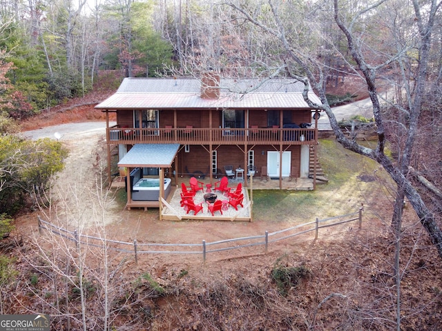 444 Miners Mountain Rd, Sautee Nacoochee, GA 30571 - rear view of property featuring a deck, a patio, a fenced backyard, driveway, and a metal roof