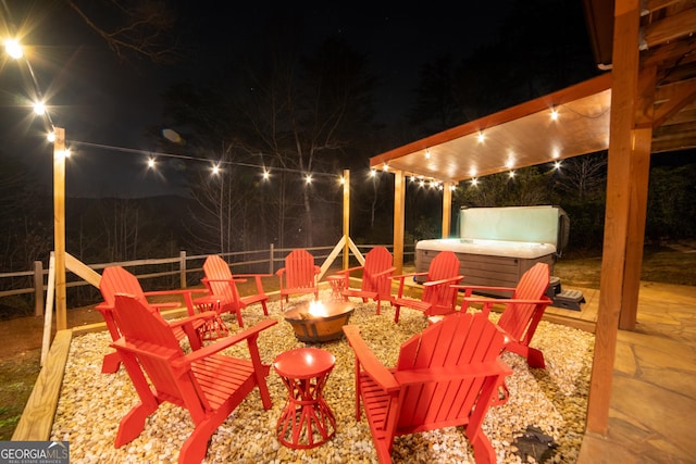 444 Miners Mountain Rd, Sautee Nacoochee, GA 30571 - patio at twilight featuring a hot tub, a fire pit, and a patio