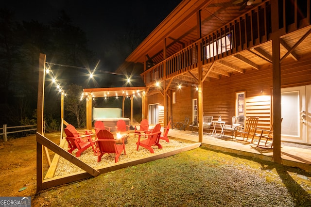 444 Miners Mountain Rd, Sautee Nacoochee, GA 30571 - patio at night with an outdoor fire pit, a hot tub, a patio area, and a balcony