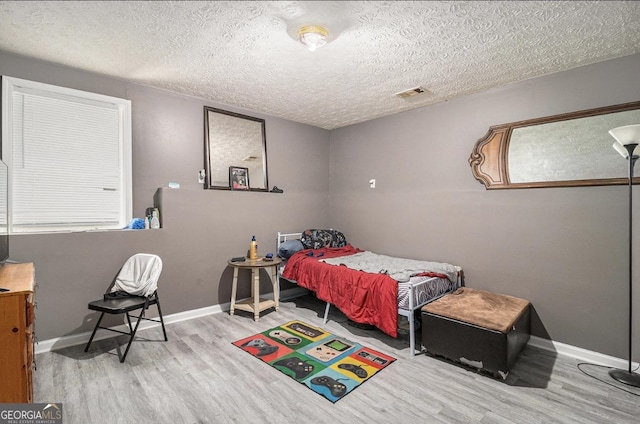 3514 Blackberry, Conyers, GA 30094 - bedroom with wood finished floors and a textured ceiling