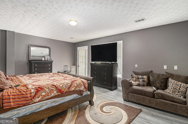 3514 Blackberry, Conyers, GA 30094 - bedroom featuring light wood-type flooring and a textured ceiling