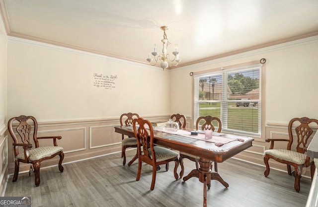 3514 Blackberry, Conyers, GA 30094 - dining space featuring ornamental molding, a chandelier, wood finished floors, wainscoting, and a decorative wall