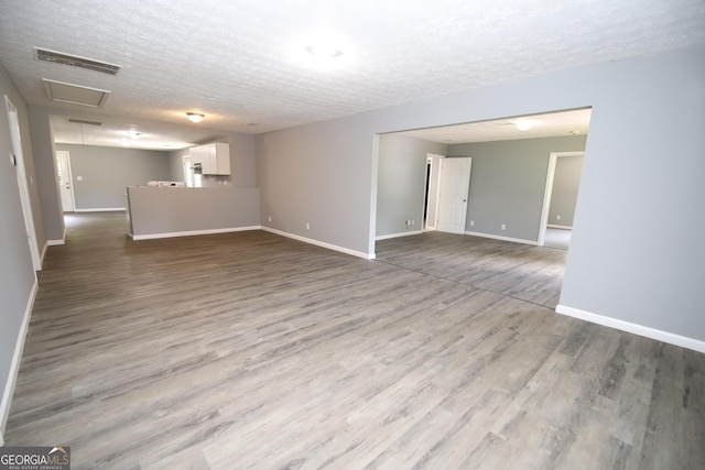 92 Priscilla Dr, Lagrange, GA 30241 - unfurnished living room featuring a textured ceiling and wood finished floors