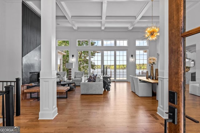 1230 Lake Club Dr, Greensboro, GA 30642 - living room with ornate columns, wood finished floors, beam ceiling, coffered ceiling, and a high ceiling