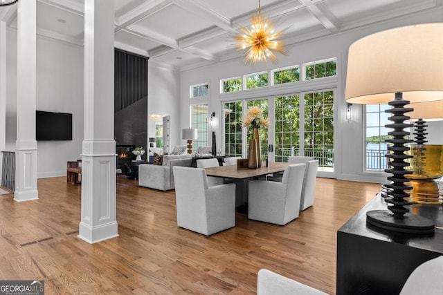 1230 Lake Club Dr, Greensboro, GA 30642 - dining area with a towering ceiling, decorative columns, coffered ceiling, light wood-style floors, and beamed ceiling