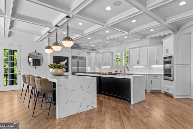 1230 Lake Club Dr, Greensboro, GA 30642 - kitchen with appliances with stainless steel finishes, a large island, plenty of natural light, coffered ceiling, and recessed lighting