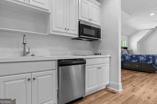 1230 Lake Club Dr, Greensboro, GA 30642 - kitchen featuring appliances with stainless steel finishes, white cabinetry, light countertops, light wood-type flooring, and recessed lighting