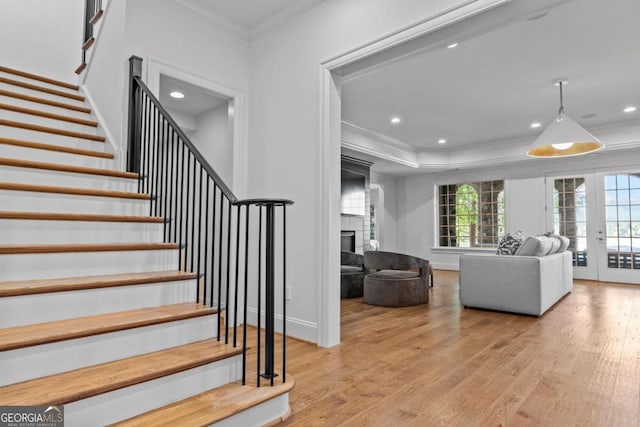 1230 Lake Club Dr, Greensboro, GA 30642 - staircase with crown molding, wood finished floors, french doors, a large fireplace, and recessed lighting