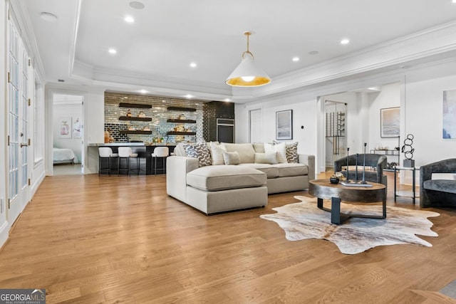 1230 Lake Club Dr, Greensboro, GA 30642 - living area featuring a raised ceiling, light wood-style floors, crown molding, recessed lighting, and bar area