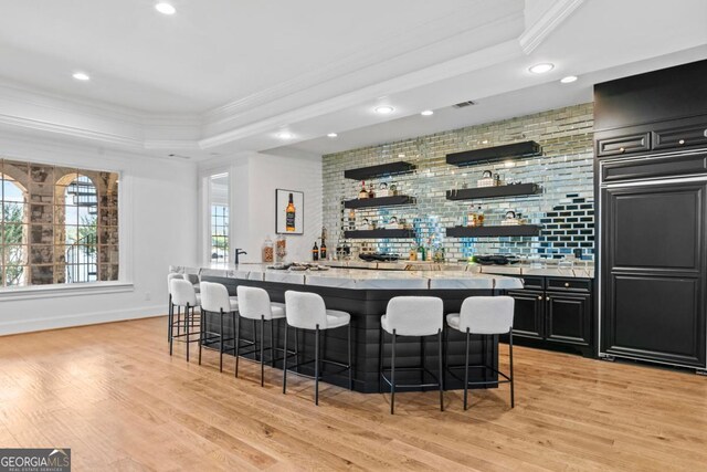 1230 Lake Club Dr, Greensboro, GA 30642 - indoor wet bar featuring ornamental molding, recessed lighting, light wood-style flooring, a raised ceiling, and backsplash