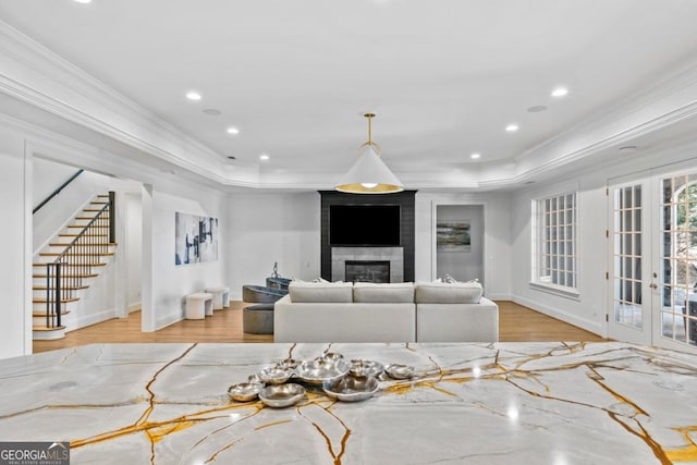 1230 Lake Club Dr, Greensboro, GA 30642 - living area with a raised ceiling, crown molding, stairway, wood finished floors, and a large fireplace